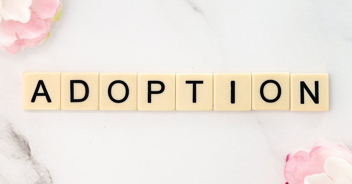 Letter tiles spelling out "adoption"